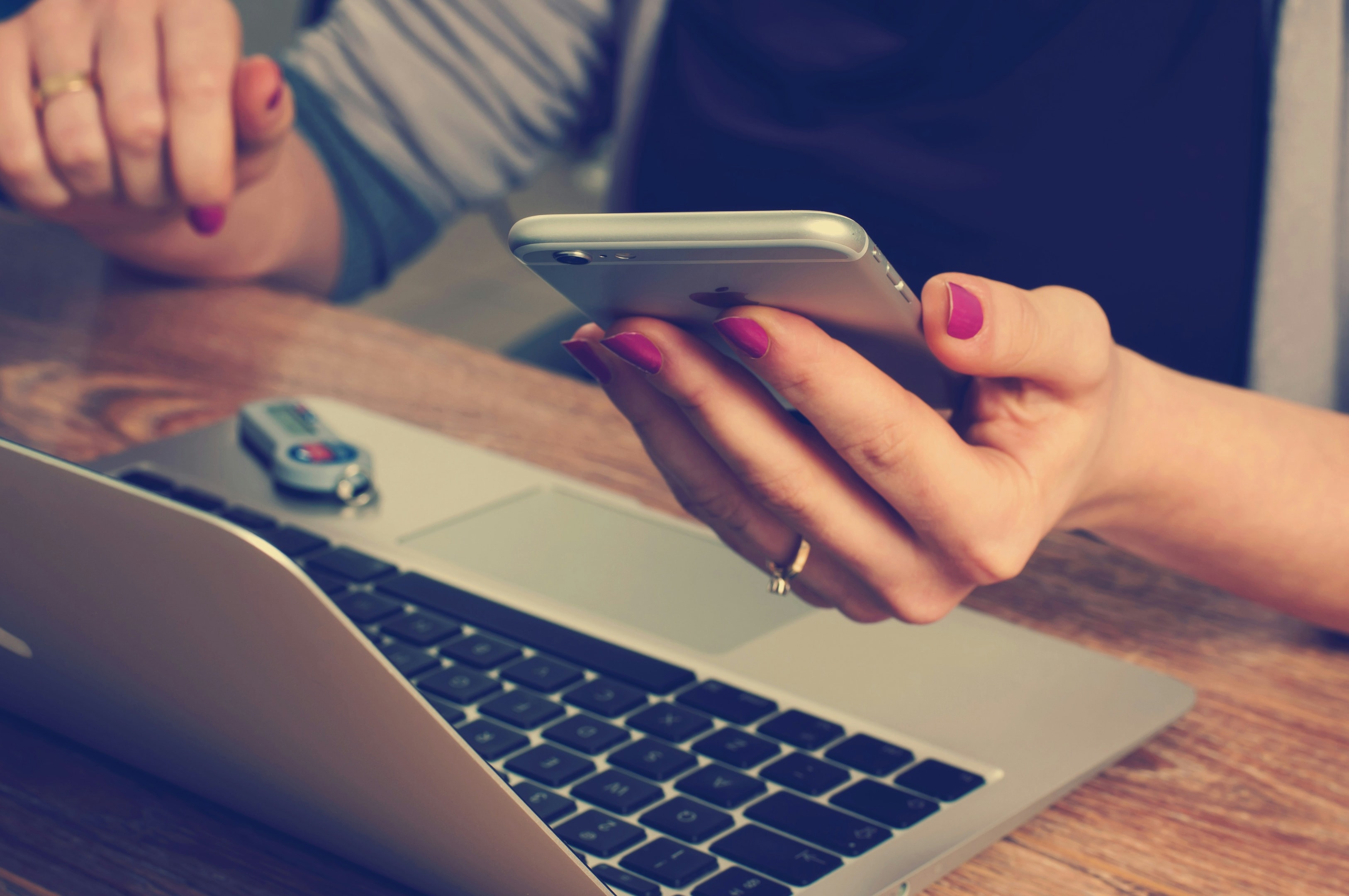 Managing Salesforce contacts across devices, with a phone and laptop in use.